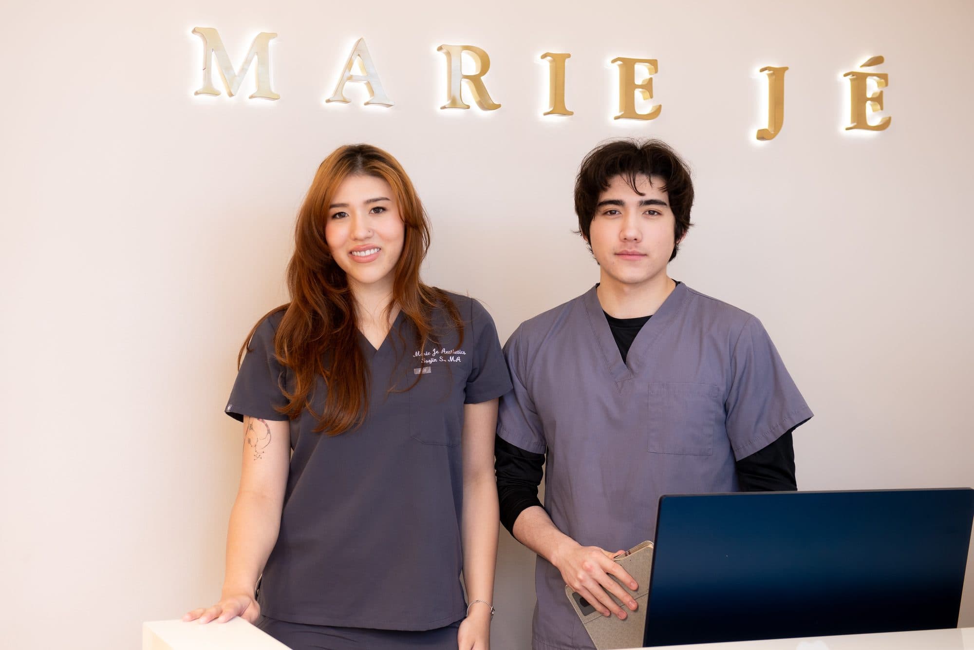 Two Marie Jé Aesthetics medical assistants at the front desk