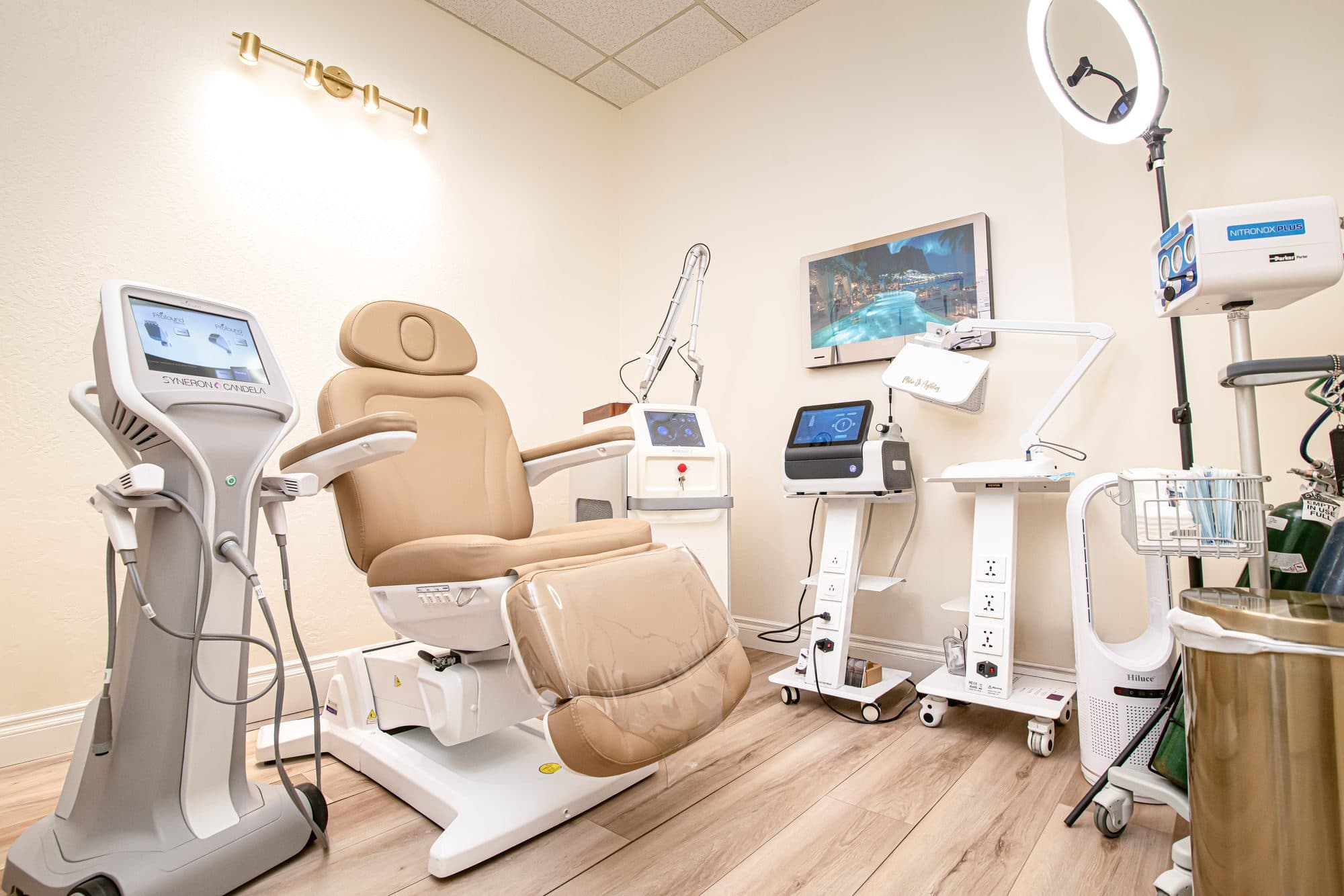 A private treatment room at Marie Jé Aesthetics with its treatment chair and laser systems