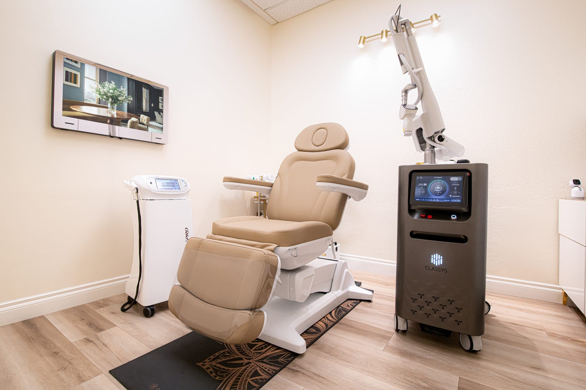 A private treatment room at Marie Jé Aesthetics with brass lighting